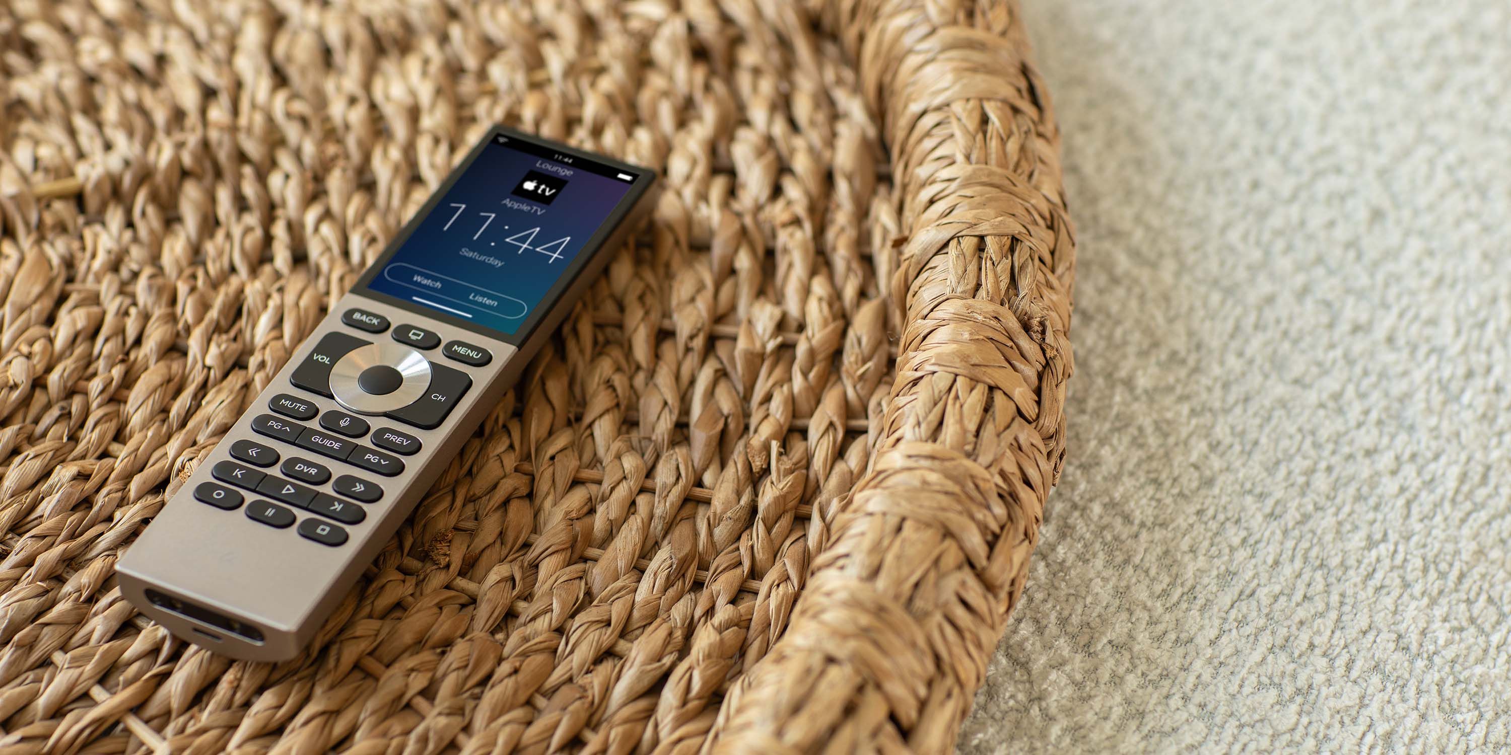 Control4 Touch panel in a able with a traditional home in the background